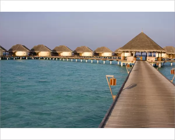 Hotel huts on stilts with jetty in the Maldives