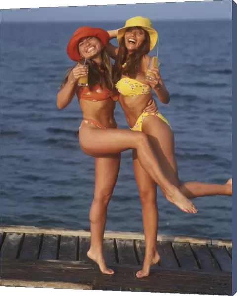 Two girls having fun by the beach