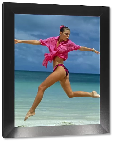 Young woman jumping on the beach