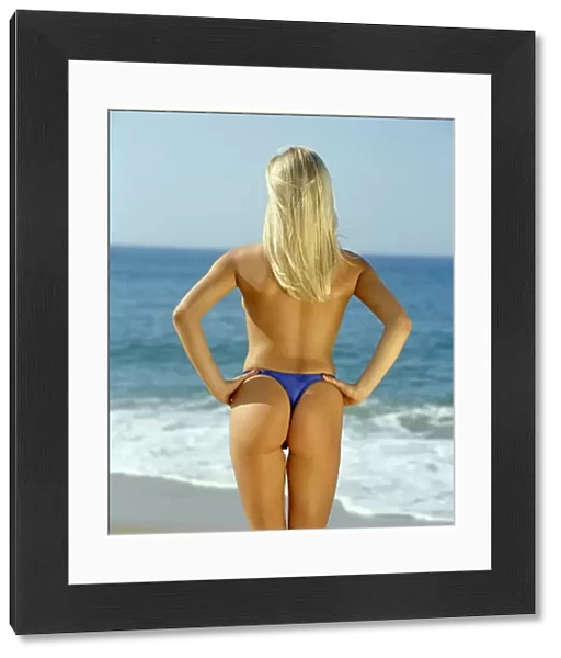 Anna Taverner, back view, blue bikini, looking out to sea
