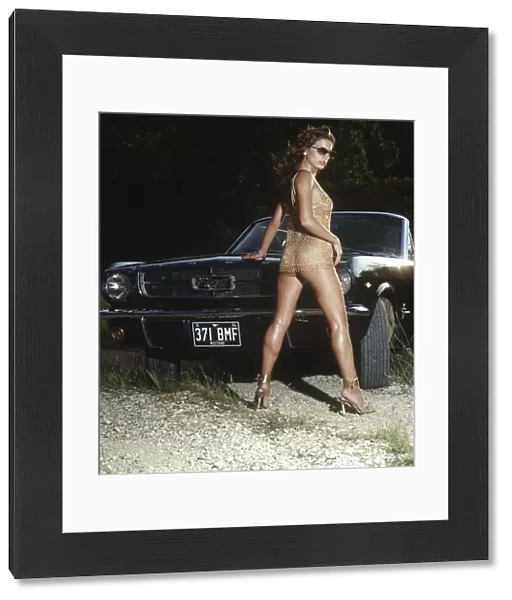 Girl pin-up outdoors with a car