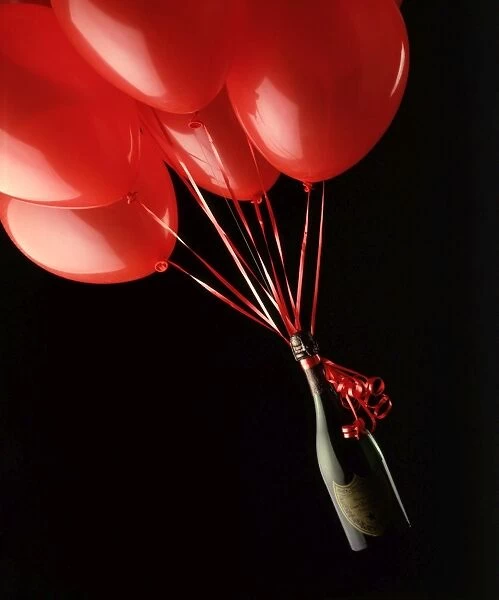 Champagne bottle floating by some red balloons Christmas & New Years
