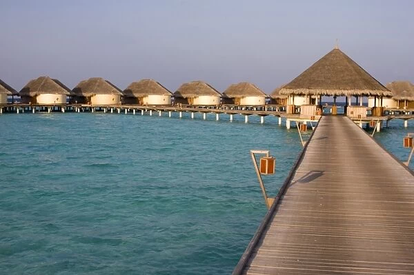 Hotel huts on stilts with jetty in the Maldives