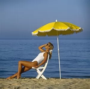 Generic Gallery: Generic, shot, of, beautiful, female, on, the, beach, with, yellow, umbrella, holiday