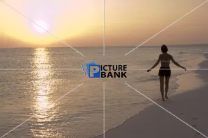 Back Gallery: Girl walking on the beach at sunset in the Maldives