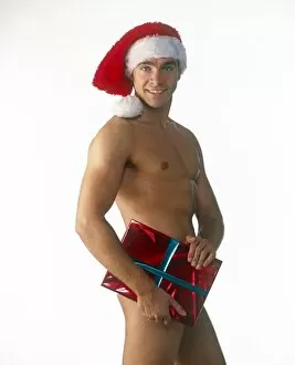Christmas & New Years Collection: Man, male, pin-up, indoors, wearing, santa, hat, christmas, present, sexy, great