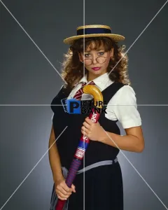 Hair Gallery: Maria Whittaker, dressed as schoolgirl, holding a hockey stick