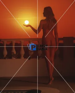 Back shot of a nude girl at sunset