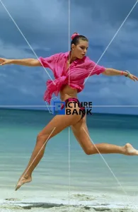 Young woman jumping on the beach